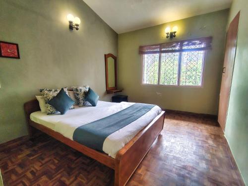 a bedroom with a large bed in a room at VILLA LEELA's WITH HOME THEATRE in Kodaikānāl