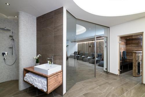 a bathroom with a sink and a glass shower at VAYA St Anton in Sankt Anton am Arlberg