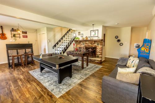 a living room with a ping pong table at Pickleball Pool Table Hot Tub FirePit King Bed in Blakeslee