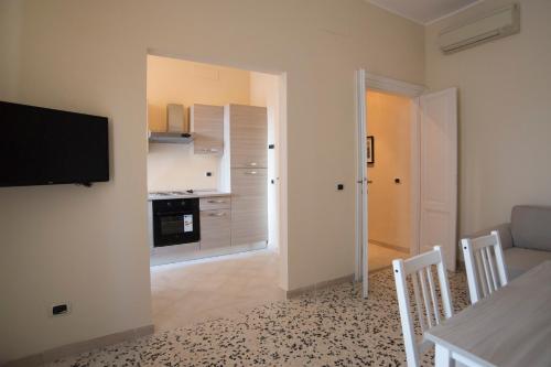 a living room with a table and a tv on a wall at Capital Flat 9/b in Rome