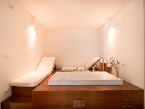 a bathroom with a large white tub in a room at Elegant villa with pool in Senigallia