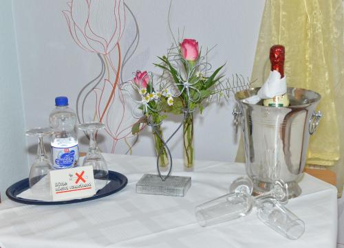 a table topped with a white table with flowers in a blender at Goldene Krone in Belgershain