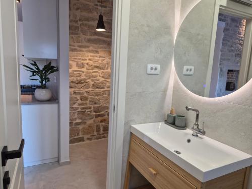 a bathroom with a sink and a mirror at Mareya Premium Stay in Poreč