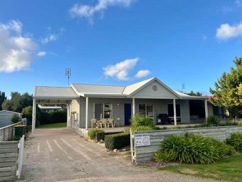 a house with a fence in front of it at SUMMER DAYSIES - Pet Friendly WiFi in Robe