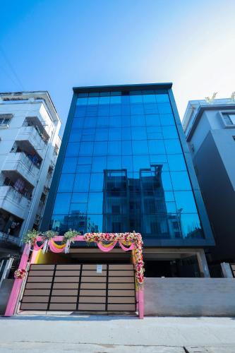 a large glass building with a gate with flowers on it at The Bay Suites - NIS in kolkata