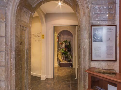 a hallway with an archway in a building at Louvre Marsollier Opera in Paris