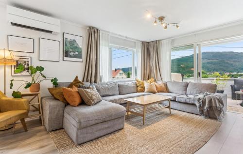 a living room with a couch and a table at Awesome Apartment In Strandebarm in Strandebarm
