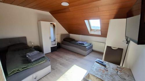 a small room with a bed and a couch at Wohnung Maric bis zu 11 Personen in Neunburg vorm Wald