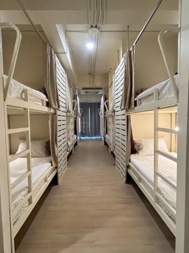 a row of bunk beds in a dorm room at Wonderful inn in Pattaya