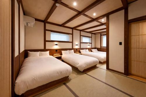 a bedroom with two beds in a room at nikko nagomi 和み in Nikko