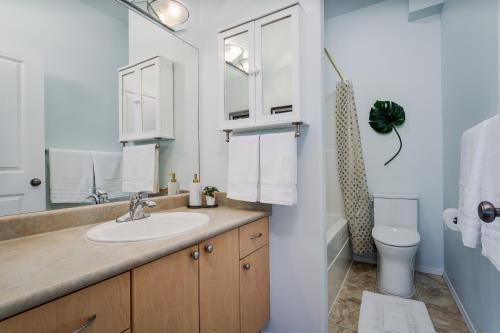 a bathroom with a sink and a toilet at Ravenwood Stay With Ocean View in Victoria