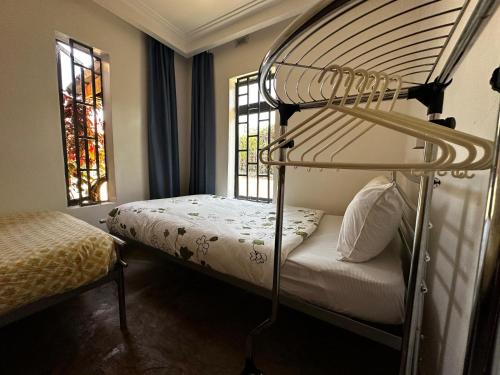 a bedroom with a bunk bed and a window at Homely Cottage Near Lake Naivasha, Elwai Visitor Centre in Heni Village