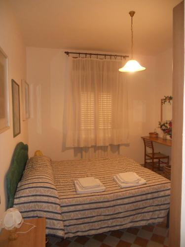a bedroom with a bed with two towels on it at Il Pozzo Della Citerna in Castelnuovo Berardenga