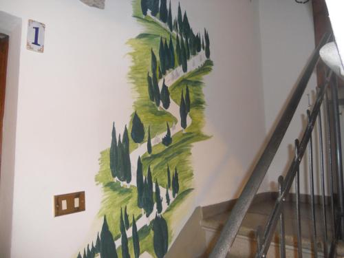 a painting of trees on a wall at Il Pozzo Della Citerna in Castelnuovo Berardenga