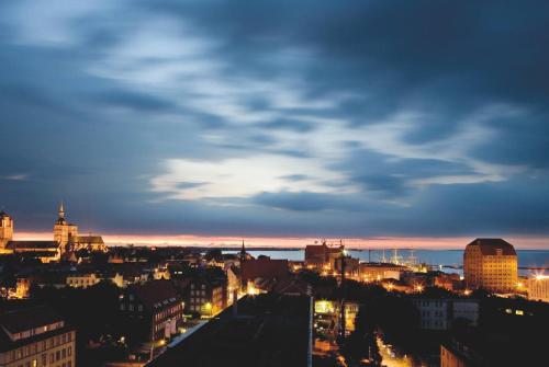 a view of a city skyline at night at Vienna House by Wyndham Baltic Stralsund in Stralsund