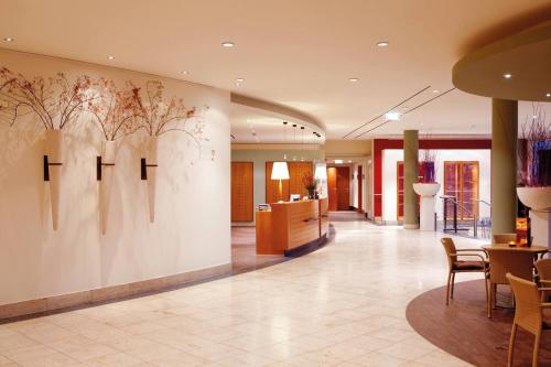 a lobby of a hotel with a wall with the word faith at Vienna House by Wyndham Baltic Stralsund in Stralsund
