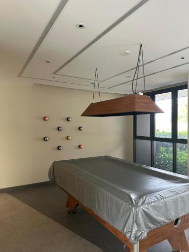 a room with a ping pong table and a climbing wall at Avrora Laguna Residences Sky Park in Ban Thalat Choeng Thale