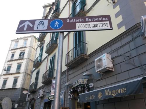 a street sign in front of a building at Casetta Piazza Plebiscito in Naples