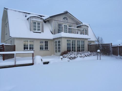 a house is covered in snow at The White House in Reykholt