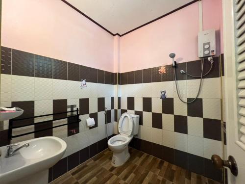 a bathroom with a toilet and a sink and a shower at Ariya Garden Home in Chumphon