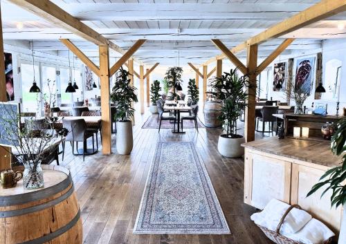 a room with tables and chairs and potted plants at Gram Slot in Gram