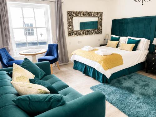 a bedroom with a large bed and a couch at Market View 1 in Hexham