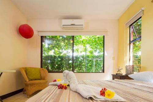 a bedroom with a bed and a large window at Playa Potrero Apartments in Potrero
