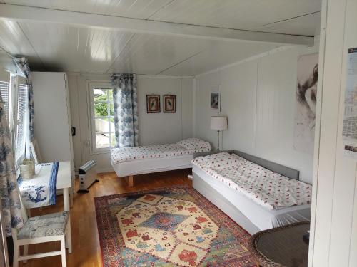 a room with two beds and a window at Ålesund New Guesthouse in Ålesund