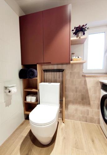 a bathroom with a toilet and a sink at Arte Golf Apartment in Kuressaare