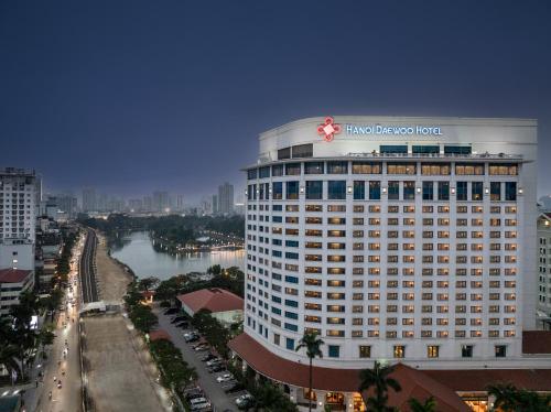 a large building with a sign on the top of it at Hanoi Daewoo Hotel in Hanoi
