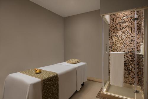 a room with two tables and a shower at Surat Marriott Hotel in Surat