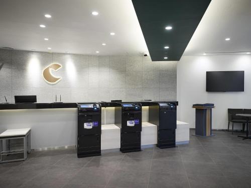 a gas station with three washers and a television at Comfort Hotel Wakayama in Wakayama