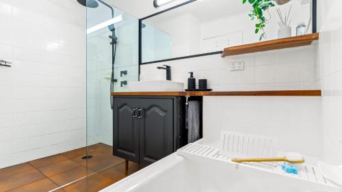 a bathroom with a sink and a shower at Keyside Escape in Forster