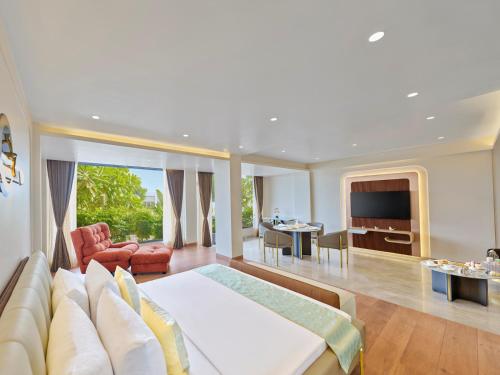 a hotel room with a bed and a living room at Empire By Zuper in Bhopal