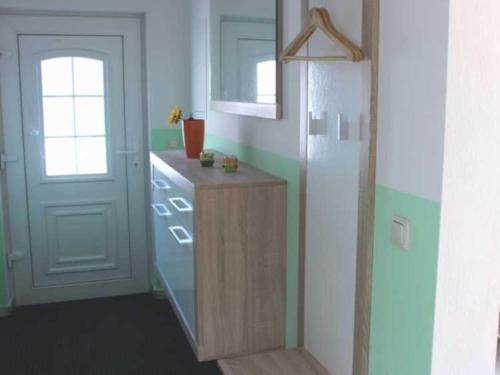 a kitchen with a white refrigerator and a white door at Ferienhaus Ostsee Antje Bellmann in Kemnitz
