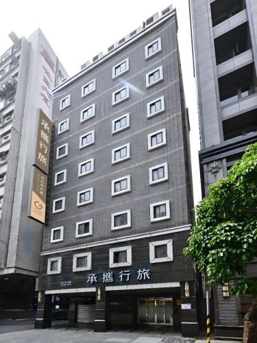 a tall gray building with chinese writing on it at Guide Hotel Taipei NTU in Taipei