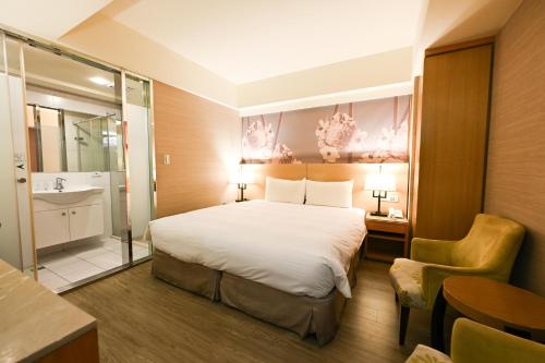a hotel room with a bed and a bathroom at Guide Hotel Taipei NTU in Taipei
