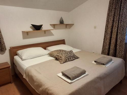 a bedroom with a bed with two towels on it at Apartman Premantura Rumora in Premantura