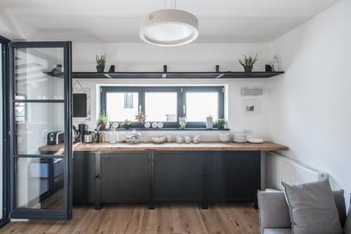 a kitchen with a sink and a window at The Pines Boutique Villa in Braşov