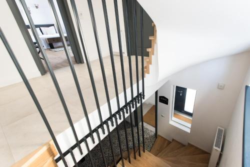a staircase with black railings in a house at The Pines Boutique Villa in Braşov