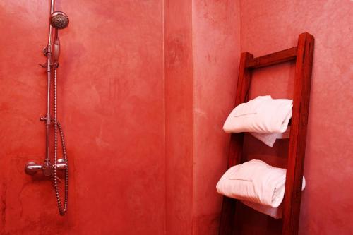 a bathroom with a shower with white towels at Riad Jamaï in Fès