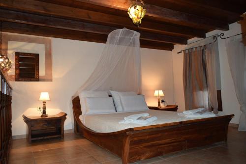 a bedroom with a bed with a mosquito net at Petrino in Rhodes Town