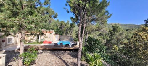 a house with a wooden deck in the middle of trees at Villa Palama in Marseille