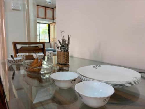 a glass table with three bowls on top of it at My second home at Nashik in Nashik