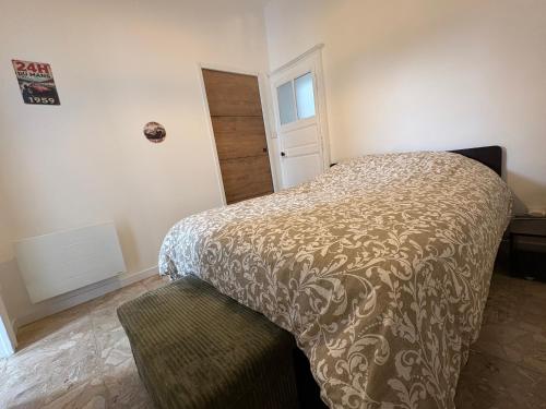 a bedroom with a bed and a door in it at Chez Rémi in Écommoy