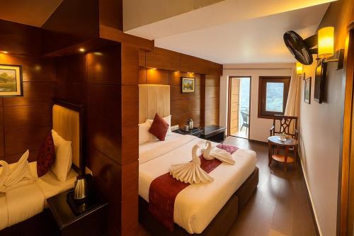 a hotel room with two beds in a room at Hotel Morning Lake in Nainital