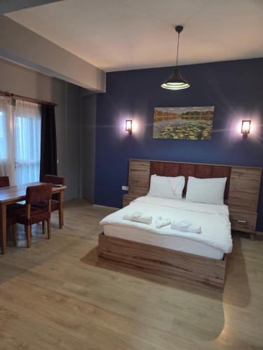 a bedroom with a large bed and a table at Elizim Otel in İzmir
