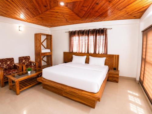 a bedroom with a bed and a wooden ceiling at Babutaal Resort in Chakrāta