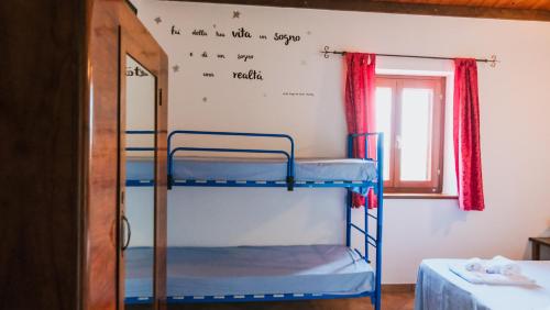 a room with two bunk beds and a window at IL Podere del nonno in Ripatransone