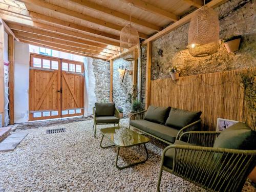 a living room with a couch and chairs and a door at Ferienhaus Glockenklang in Sangerhausen